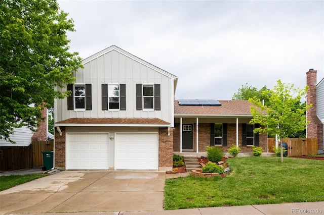 4760 S Wright Way, Morrison, CO 80465 - tri-level home featuring board and batten siding, roof mounted solar panels, a porch, an attached garage, and driveway