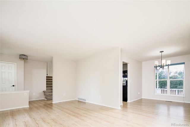 4760 S Wright Way, Morrison, CO 80465 - unfurnished living room with light wood-style flooring, a chandelier, and stairway