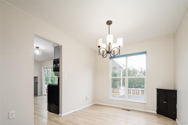 4760 S Wright Way, Morrison, CO 80465 - unfurnished dining area featuring a chandelier and light wood-style floors