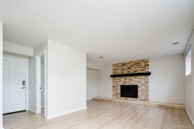 4760 S Wright Way, Morrison, CO 80465 - unfurnished living room with light wood-style floors and a fireplace