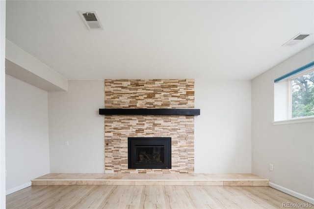 4760 S Wright Way, Morrison, CO 80465 - unfurnished living room with wood finished floors and a tiled fireplace