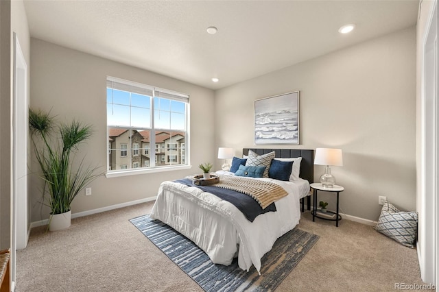 bedroom with baseboards, recessed lighting, and light colored carpet