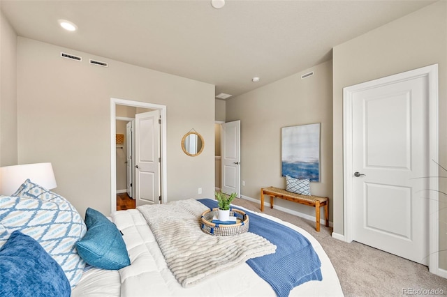 bedroom featuring visible vents, baseboards, and light colored carpet