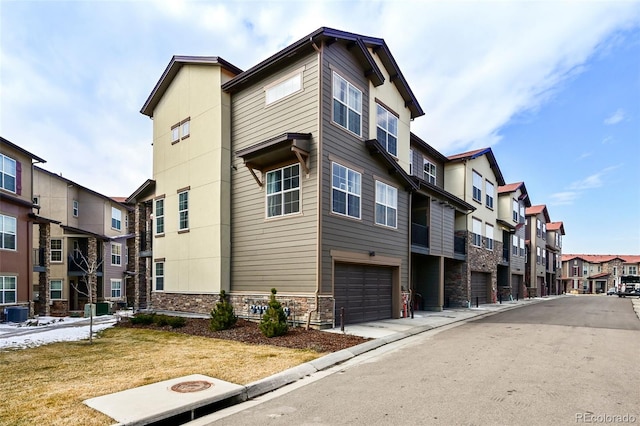 view of property featuring a garage and a residential view