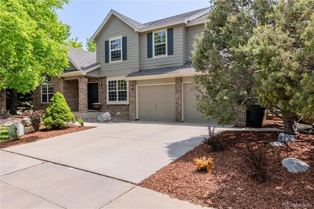 20182 E Maplewood Pl, Centennial, CO 80016 - view of front facade with concrete driveway, brick siding, a shingled roof, and an attached garage