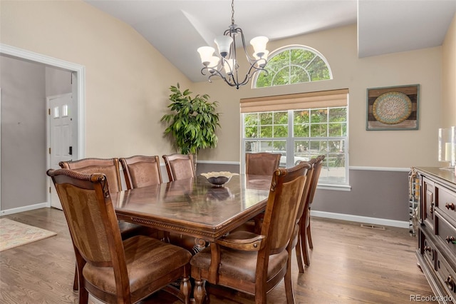 20182 E Maplewood Pl, Centennial, CO 80016 - dining space with a chandelier, wood finished floors, vaulted ceiling, and baseboards