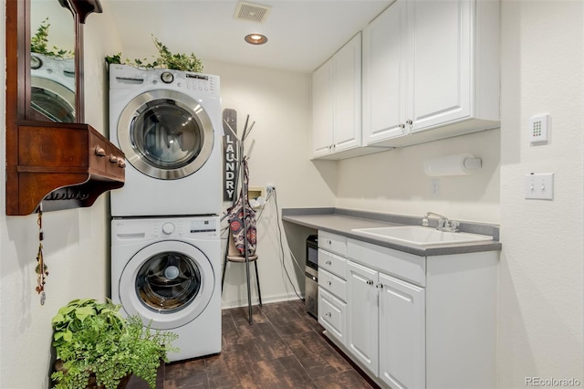 20182 E Maplewood Pl, Centennial, CO 80016 - laundry room with stacked washer / dryer, cabinet space, dark wood-style floors, baseboards, and recessed lighting