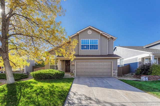 traditional-style house with a front lawn, a garage, stone siding, and driveway