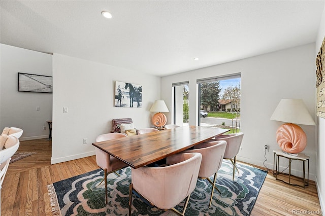 dining space with light wood-style flooring, baseboards, and recessed lighting