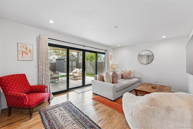 living room with wood finished floors and recessed lighting