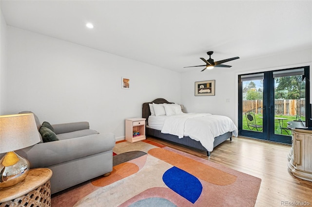 bedroom featuring access to outside, wood finished floors, french doors, a ceiling fan, and recessed lighting
