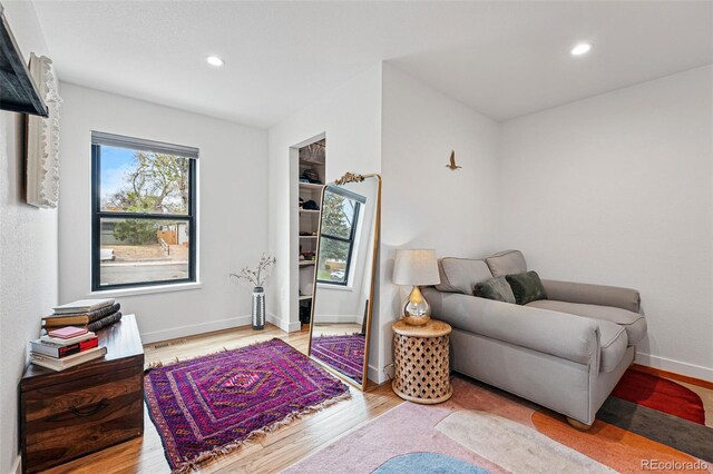 living area featuring wood finished floors, recessed lighting, and baseboards