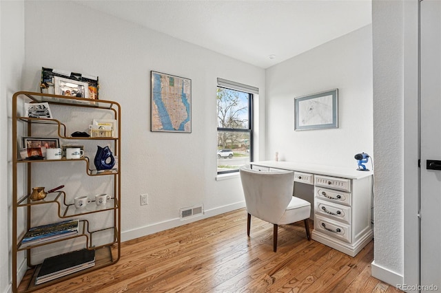 home office featuring light wood-style floors and baseboards