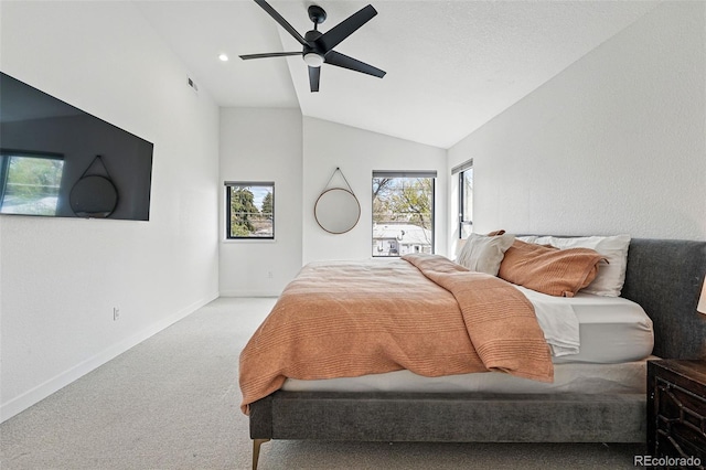 bedroom with vaulted ceiling, carpet floors, baseboards, and a ceiling fan