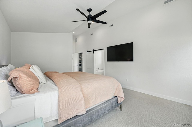 carpeted bedroom with baseboards, a ceiling fan, and a barn door