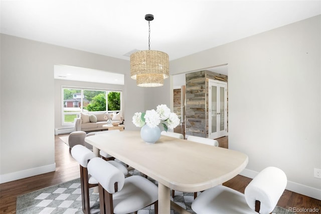 5586 Colorow Dr, Morrison, CO 80465 - dining space with a chandelier, baseboards, and wood finished floors