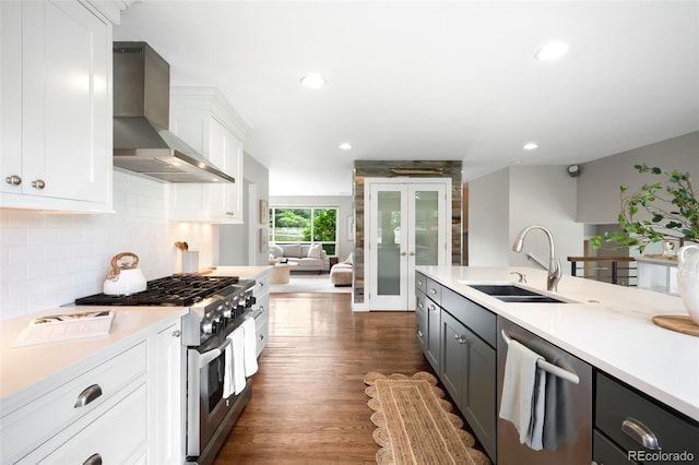 5586 Colorow Dr, Morrison, CO 80465 - kitchen with wall chimney exhaust hood, stainless steel appliances, a sink, recessed lighting, and white cabinets