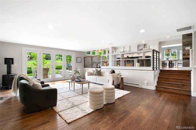 5586 Colorow Dr, Morrison, CO 80465 - living room featuring baseboard heating, french doors, wood finished floors, recessed lighting, and a wood stove
