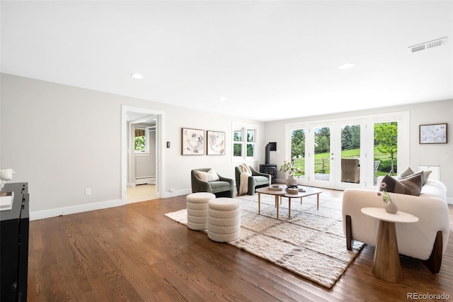 5586 Colorow Dr, Morrison, CO 80465 - living room with healthy amount of natural light, a baseboard radiator, wood finished floors, baseboards, and recessed lighting