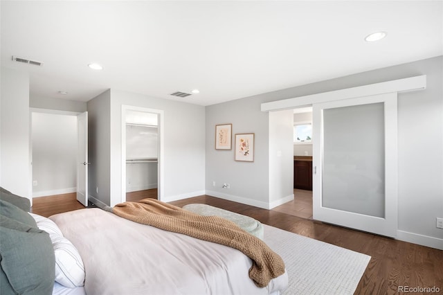 5586 Colorow Dr, Morrison, CO 80465 - bedroom featuring dark wood-style flooring, baseboards, recessed lighting, and a walk in closet