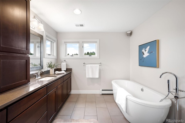 5586 Colorow Dr, Morrison, CO 80465 - full bath featuring baseboard heating, a freestanding tub, vanity, tile patterned floors, and baseboards
