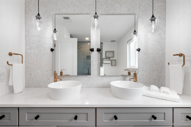 5586 Colorow Dr, Morrison, CO 80465 - full bath with double vanity, decorative backsplash, and a tile shower
