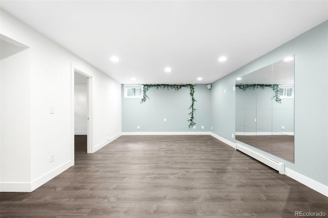 5586 Colorow Dr, Morrison, CO 80465 - basement with a baseboard radiator, baseboards, wood finished floors, and recessed lighting