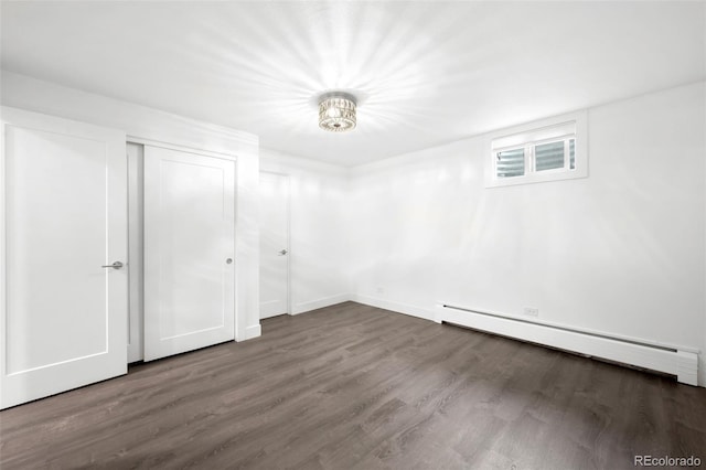 5586 Colorow Dr, Morrison, CO 80465 - unfurnished bedroom with baseboard heating, wood finished floors, and a closet