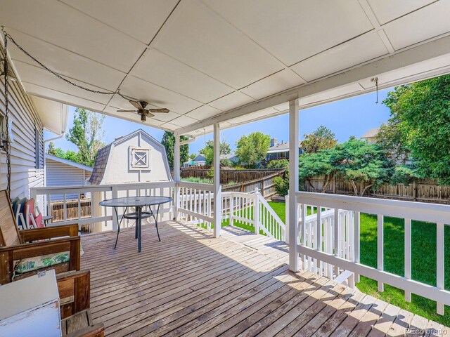 1576 S Ursula Ct, Aurora, CO 80012 - deck with a fenced backyard, a storage unit, and outdoor dining area