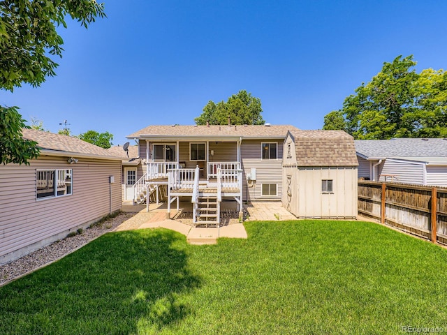 1576 S Ursula Ct, Aurora, CO 80012 - back of property with a shed, a shingled roof, a deck, stairway, and a fenced backyard