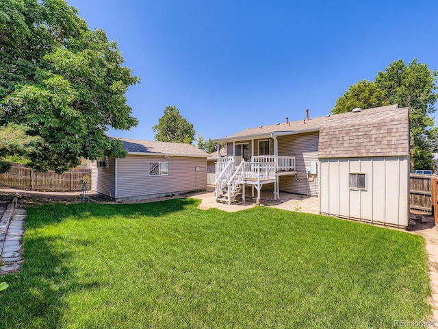 1576 S Ursula Ct, Aurora, CO 80012 - back of property with stairs, a wooden deck, a shed, and a shingled roof