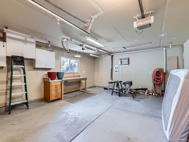 1576 S Ursula Ct, Aurora, CO 80012 - garage with a garage door opener and a wall unit AC