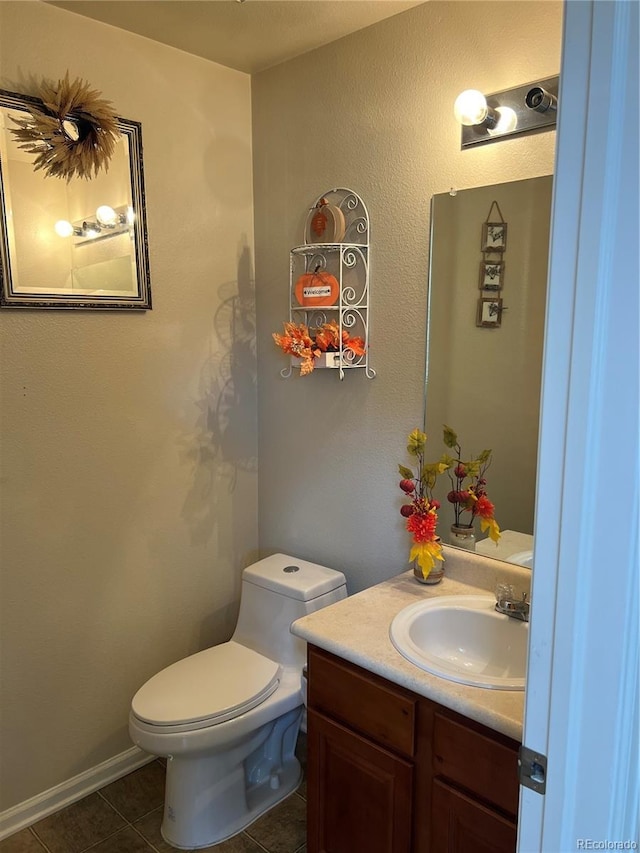 bathroom featuring vanity, toilet, and tile patterned floors