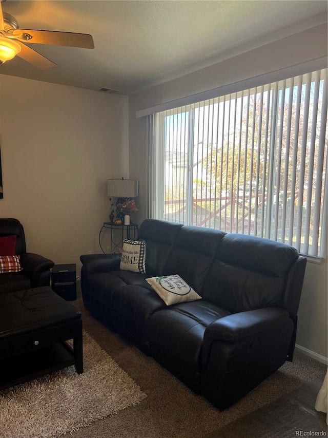 living room with carpet flooring and ceiling fan