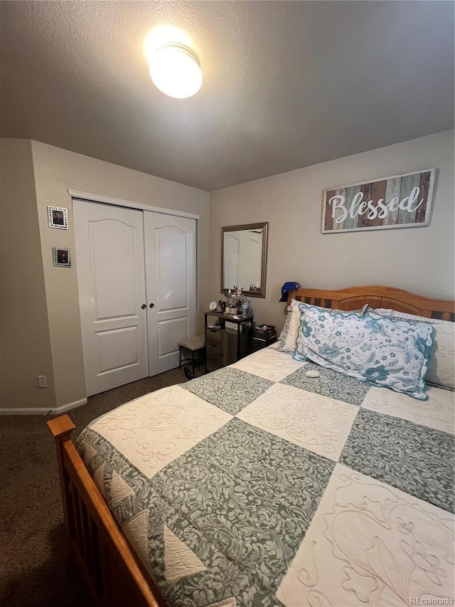 carpeted bedroom featuring a closet and a textured ceiling