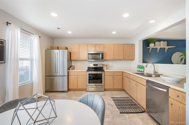 kitchen with light brown cabinets, sink, and appliances with stainless steel finishes