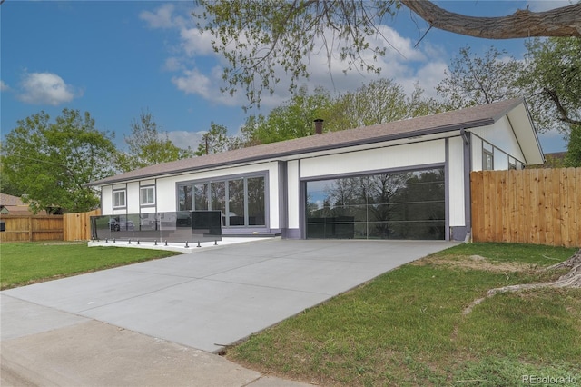 ranch-style house featuring a patio, a garage, fence, concrete driveway, and a front yard