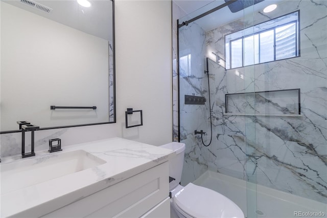 bathroom featuring visible vents, vanity, a marble finish shower, and toilet