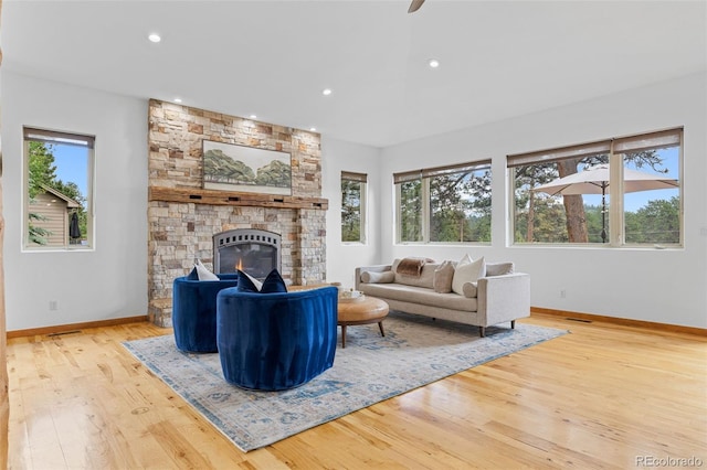 1474 Belford Ct, Evergreen, CO 80439 - living area with wood finished floors, recessed lighting, and a stone fireplace