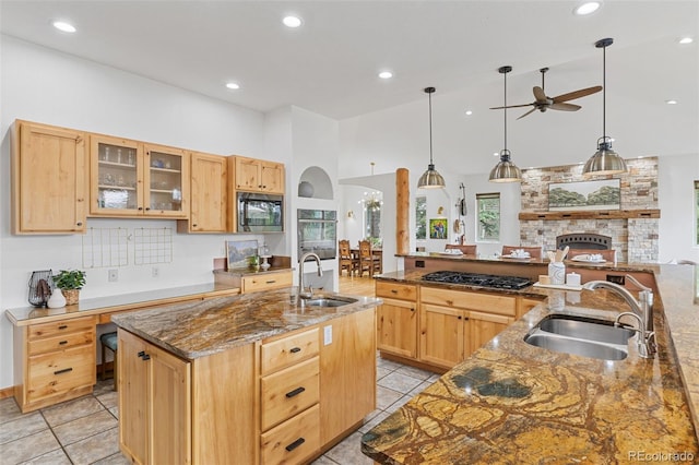 1474 Belford Ct, Evergreen, CO 80439 - kitchen featuring appliances with stainless steel finishes, light brown cabinetry, a large island, ceiling fan, and high vaulted ceiling