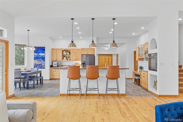 1474 Belford Ct, Evergreen, CO 80439 - kitchen with stainless steel fridge, open shelves, oven, light wood-style floors, and recessed lighting