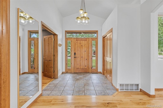 1474 Belford Ct, Evergreen, CO 80439 - entryway with a chandelier, lofted ceiling, and light tile patterned flooring