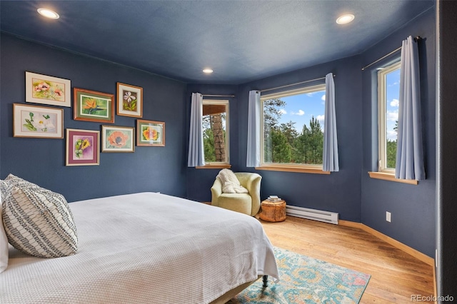 1474 Belford Ct, Evergreen, CO 80439 - bedroom with baseboard heating, wood finished floors, and recessed lighting