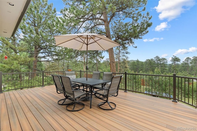 1474 Belford Ct, Evergreen, CO 80439 - deck featuring outdoor dining space and view of wooded area