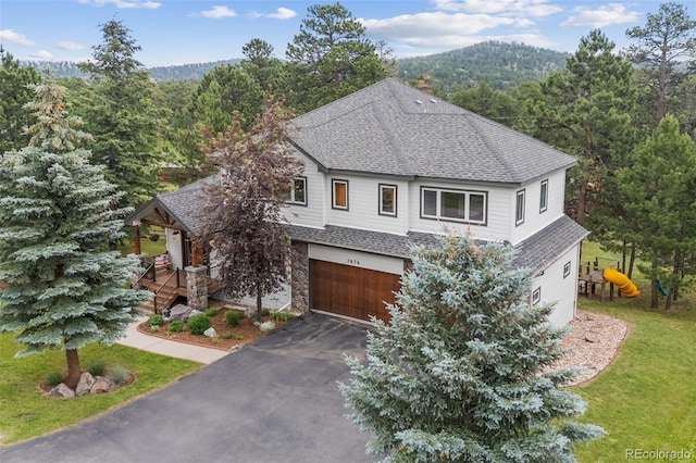 1474 Belford Ct, Evergreen, CO 80439 - view of front of property featuring roof with shingles, an attached garage, covered porch, driveway, and stone siding
