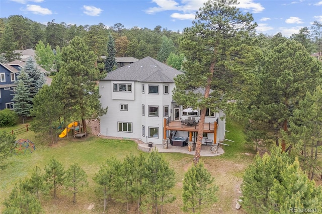 1474 Belford Ct, Evergreen, CO 80439 - back of property featuring a patio, a wooden deck, a lawn, and a playground