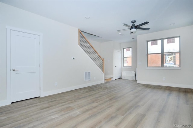 unfurnished living room featuring ceiling fan and light hardwood / wood-style floors