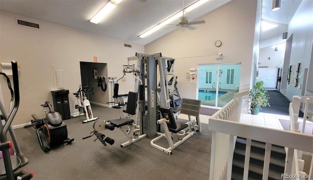 gym with high vaulted ceiling, visible vents, and a ceiling fan