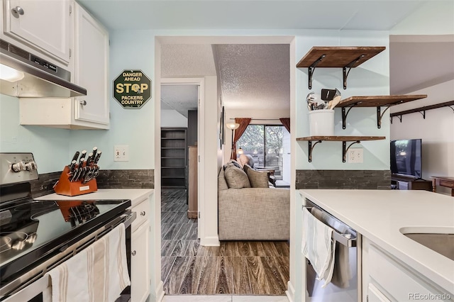 kitchen featuring stainless steel appliances, light countertops, white cabinets, and under cabinet range hood