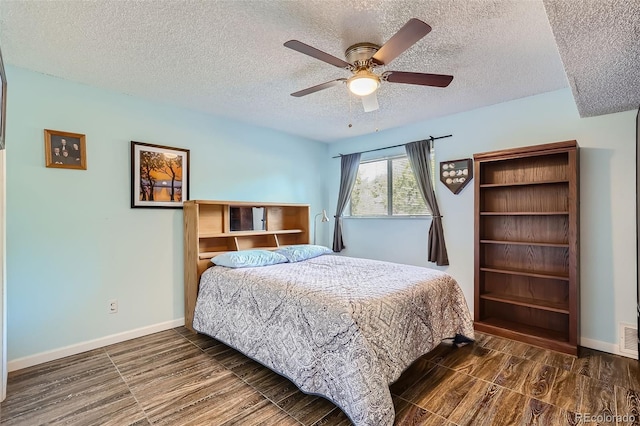 bedroom with visible vents, ceiling fan, baseboards, and wood finished floors